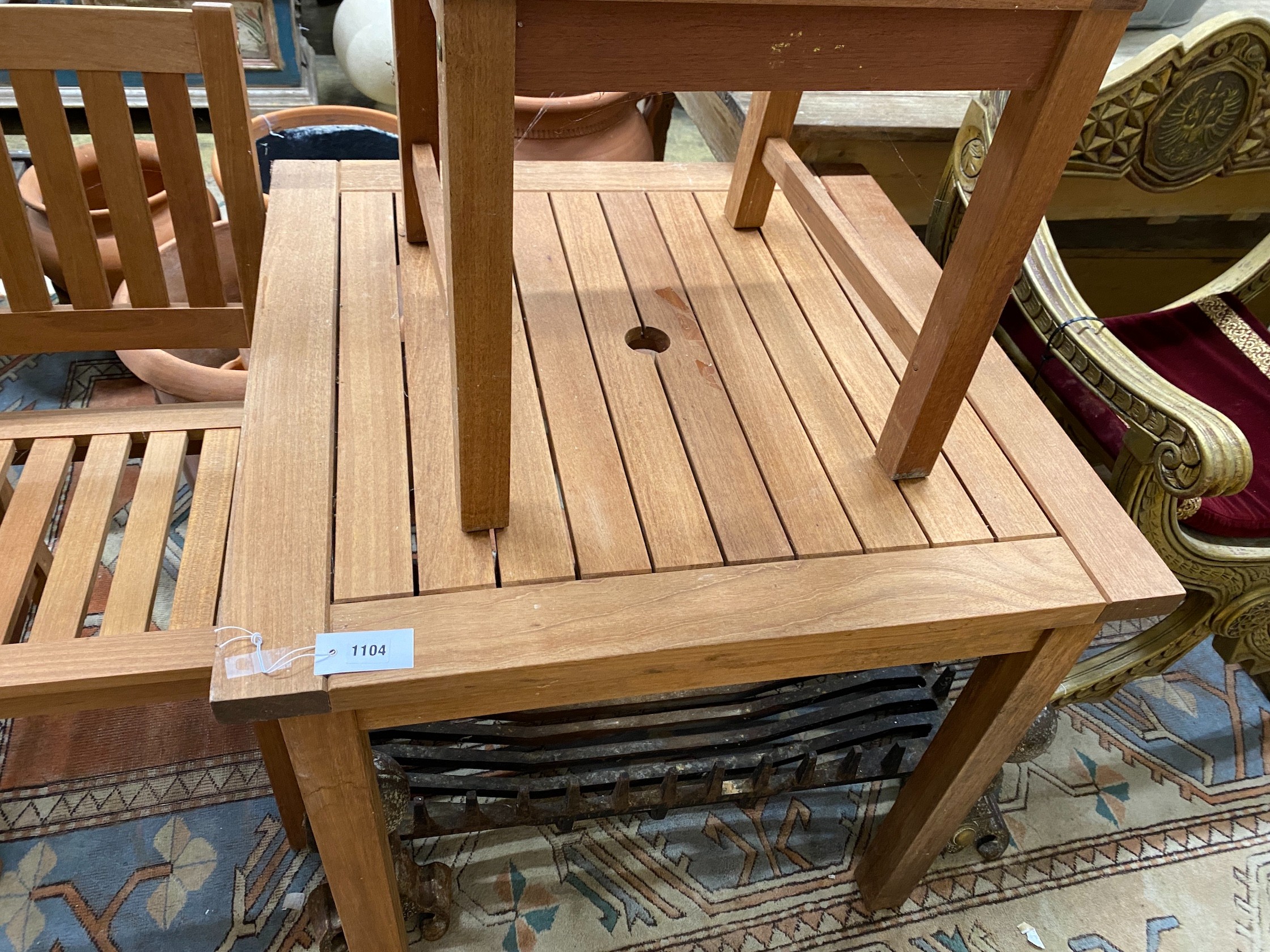 A square teak garden table, width 80cm, height 73cm together with two teak garden chairs